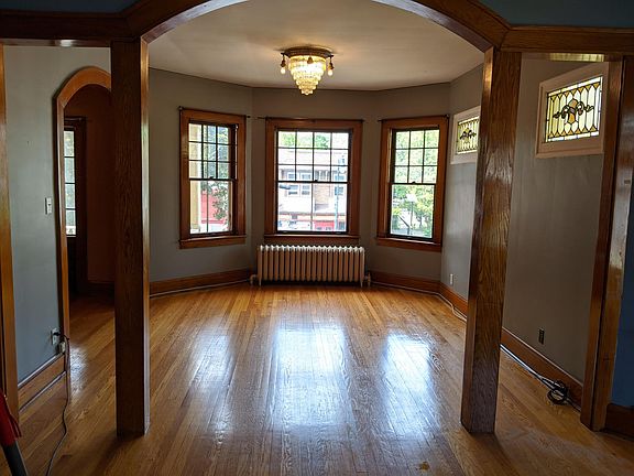 Living room with stained glass windows, original light fixture.