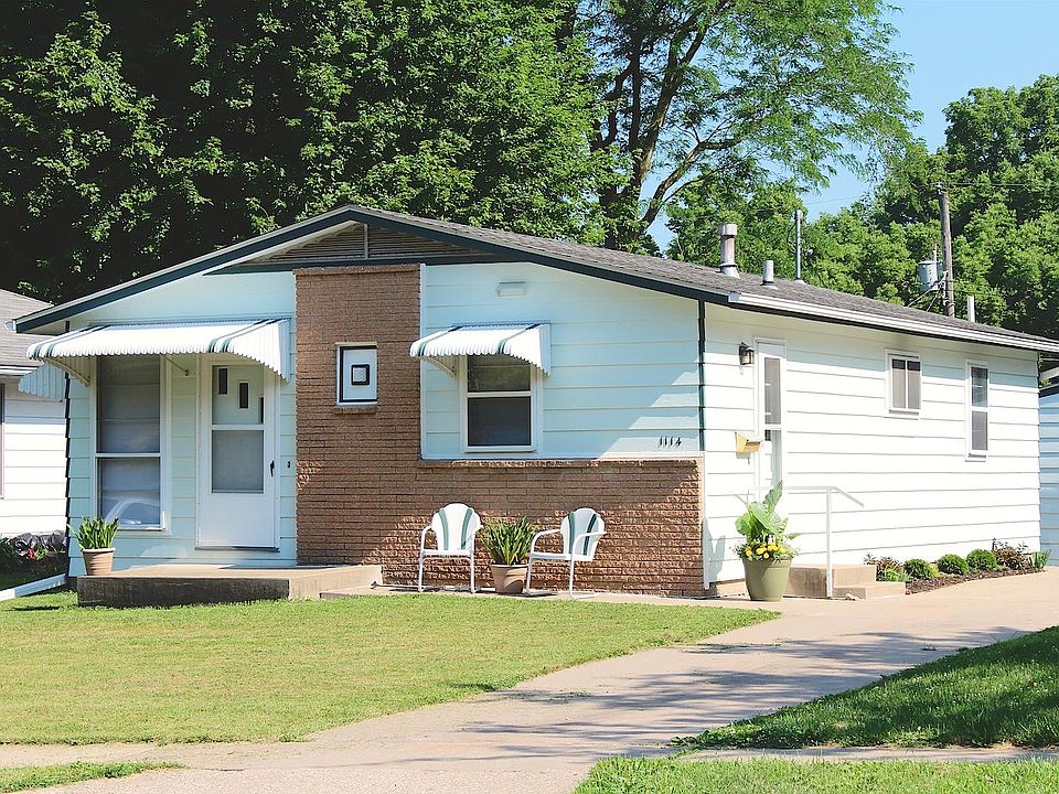 Exterior with a detached garage behind.