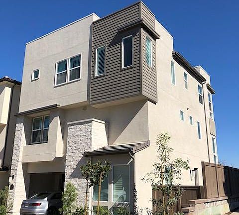 Rear exterior view with 2-car garage AND 2-vehicle carport