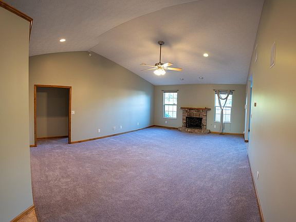 Spacious living room with vaulted ceiling.