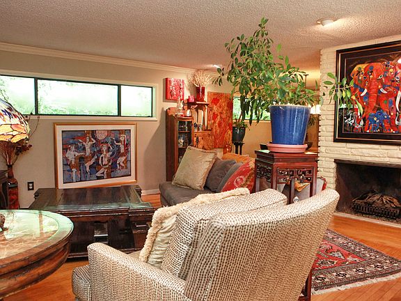 A large, open living room with plenty of natural light and a fireplace