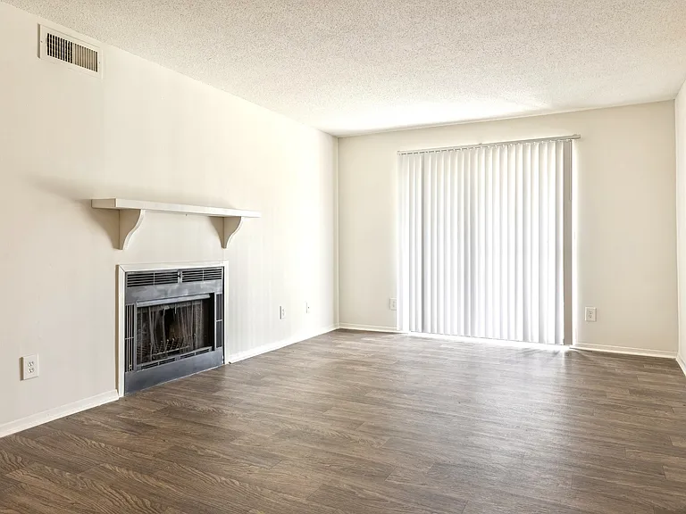 Generous living spaces feature a cozy fireplace and elegant hardwood flooring for comfortable entertaining, professionally operated by Highlands Vista Group.