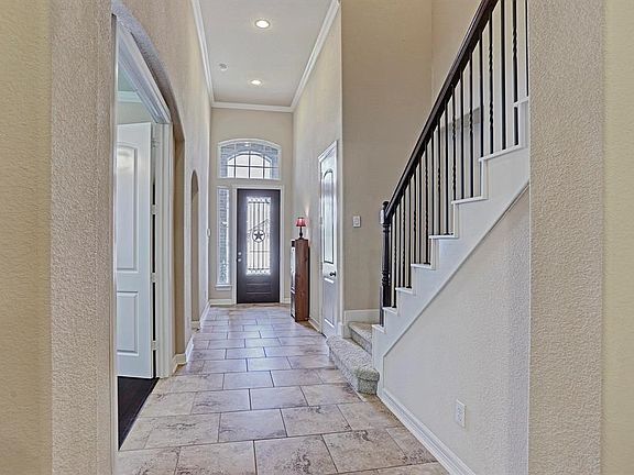 Bright and airy describe this foyer with the soaring ceilings and an abundance of light.
