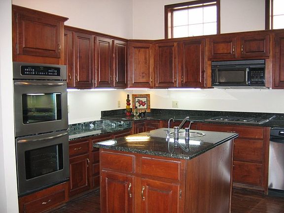 Kitchen:  Beautiful cherry wood cabinets w/granite and marble countertops; NEW