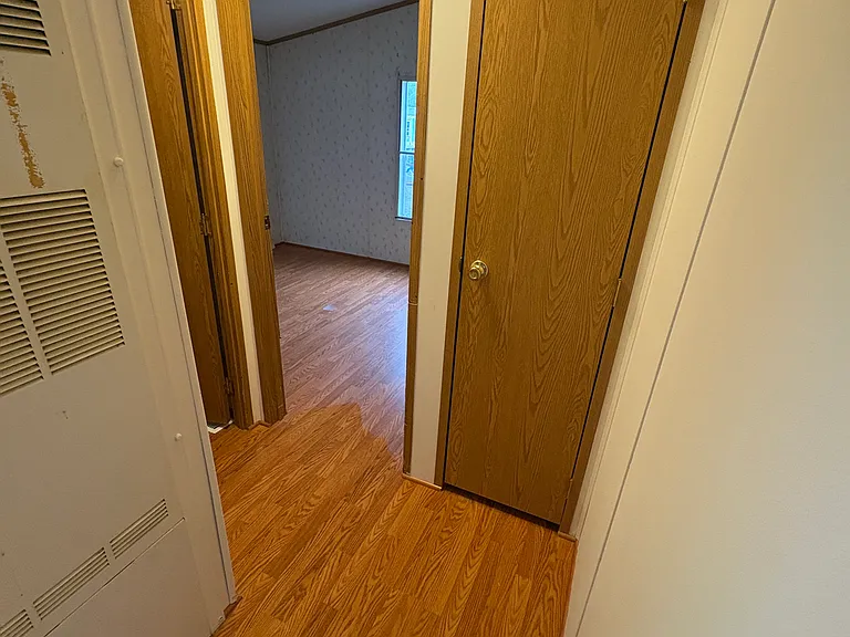 Hallway to 2nd bedroom, coat closet, 2nd full bathroom with tub