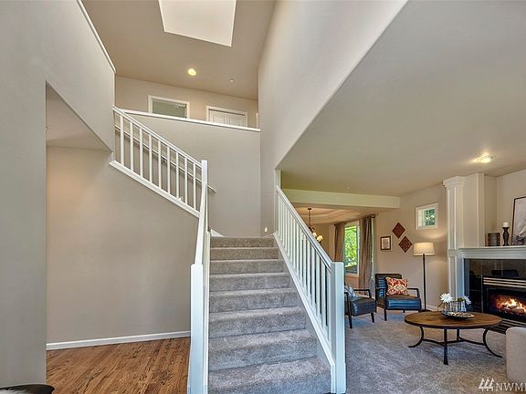The foyer is filled with natural light from a large skylight.