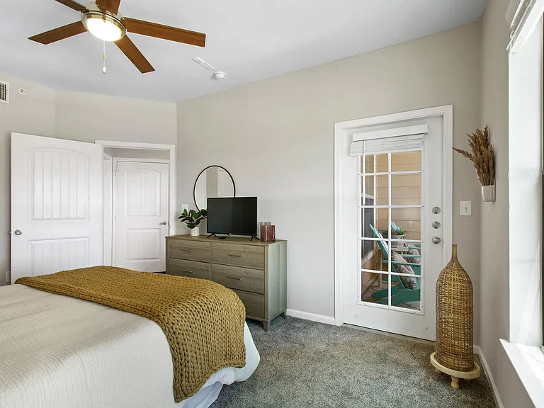 Model Bedroom With Access to Private Patio at Mission Hills Apartments, Texas, 78258