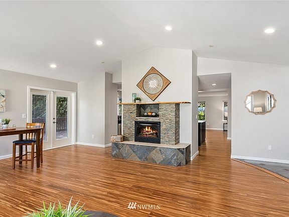 Just inside the door, the front living room with its vaulted ceilings, bamboo flooring and beautiful stacked stone fireplace.