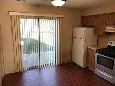 Kitchen and dining area with sliding glass door to back patio.