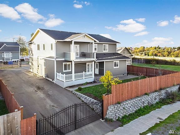 View of the back of the property with the full length driveway. Nicely landscaped with newer fencing, retaining walls, garden space & more. 