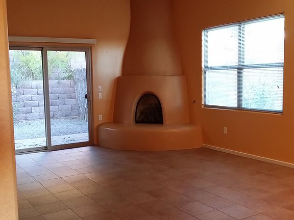 Gas kiva fireplace in living room.