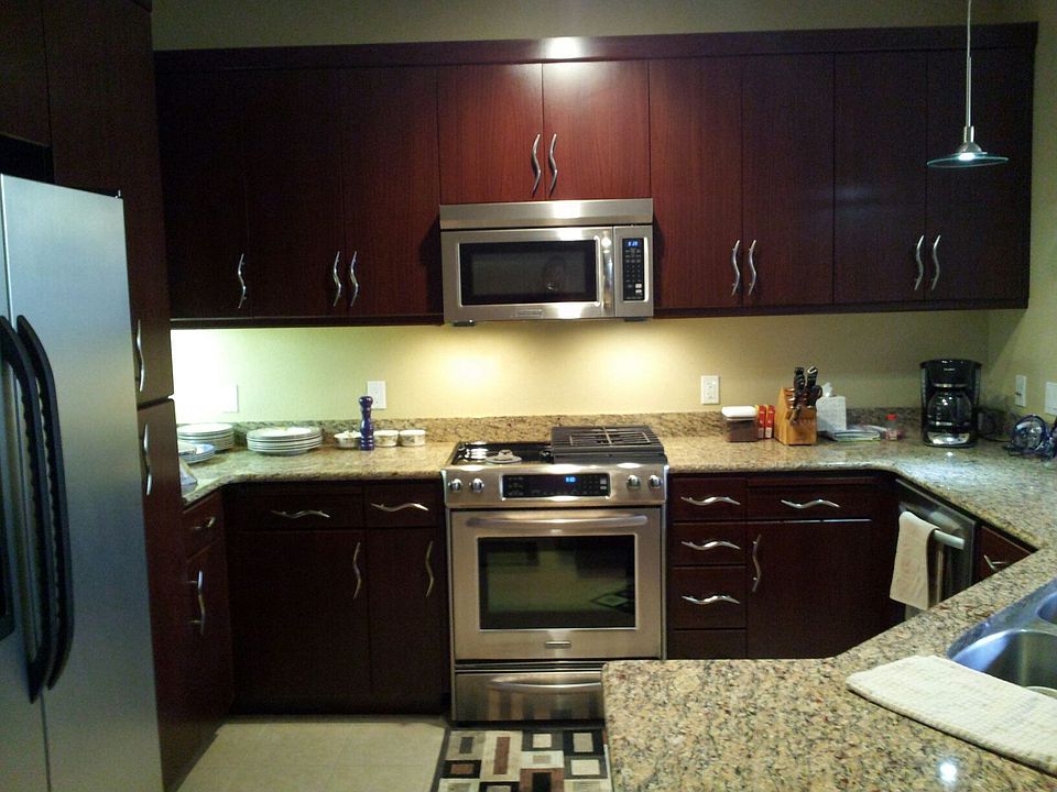 Upgraded countertops, appliances, cabinets, lighting, and tile floors.