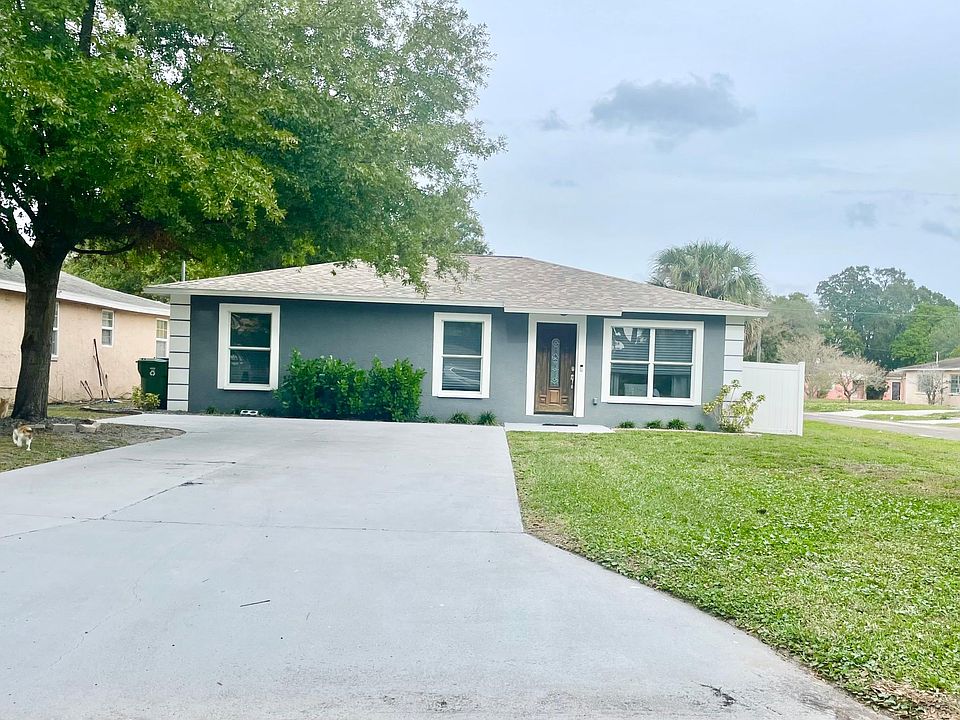 Front of house, is a corner lot so lots of front yard for activities. Driveway fits 4-5 cars, then has a rock pathway to backyard with privacy gate/fence.