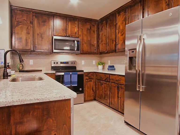 The kitchen offers stainless steel appliances, a breakfast bar with seating for 3. Refrigerator included.