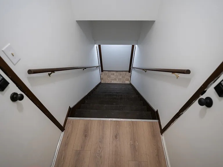 Shared stairway with auto-locking deadbolts to each unit and basement area.