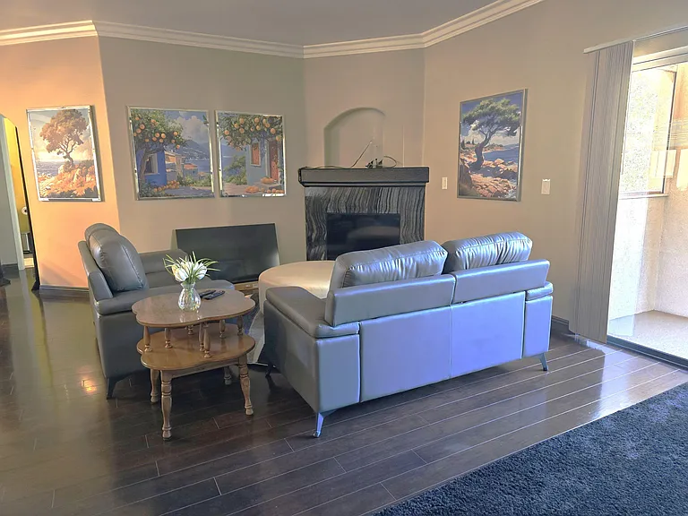 Inviting living room with comfortable seating, a fireplace focal point, and sliding-door access that brings in natural light.