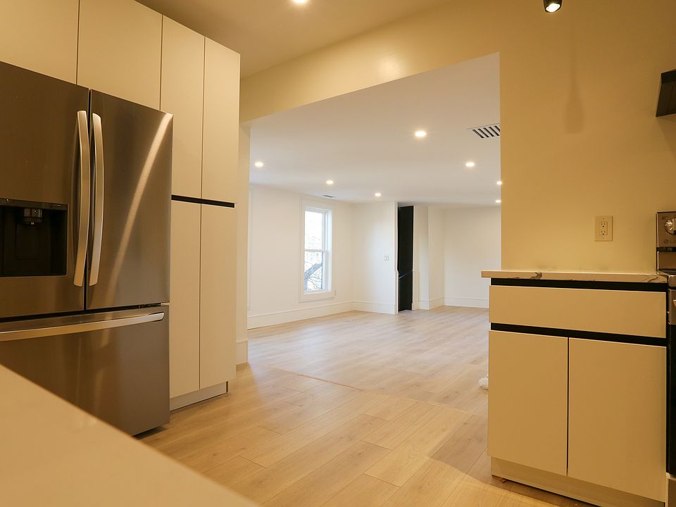 Kitchen opens to spacious living room area with private back staircase.