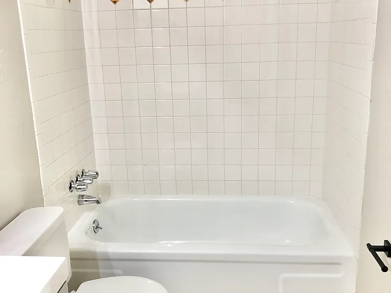 Step into this chic bathroom featuring stylish tiles and a sleek bathtub. Step into this chic bathroom featuring stylish tiles and a sleek bathtub.