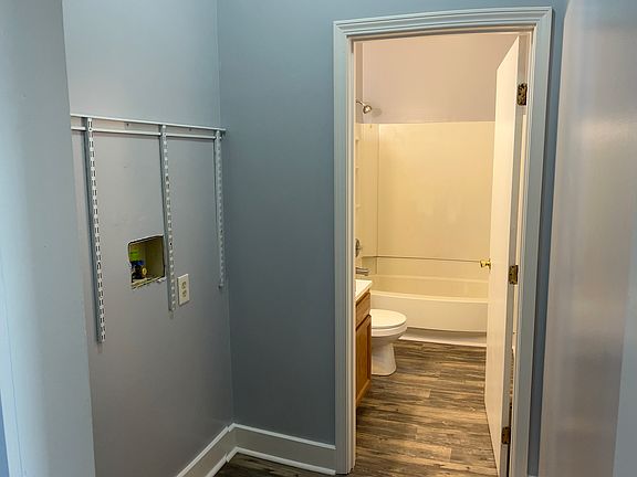 Hallway looking into laundry area pass through to bathroom