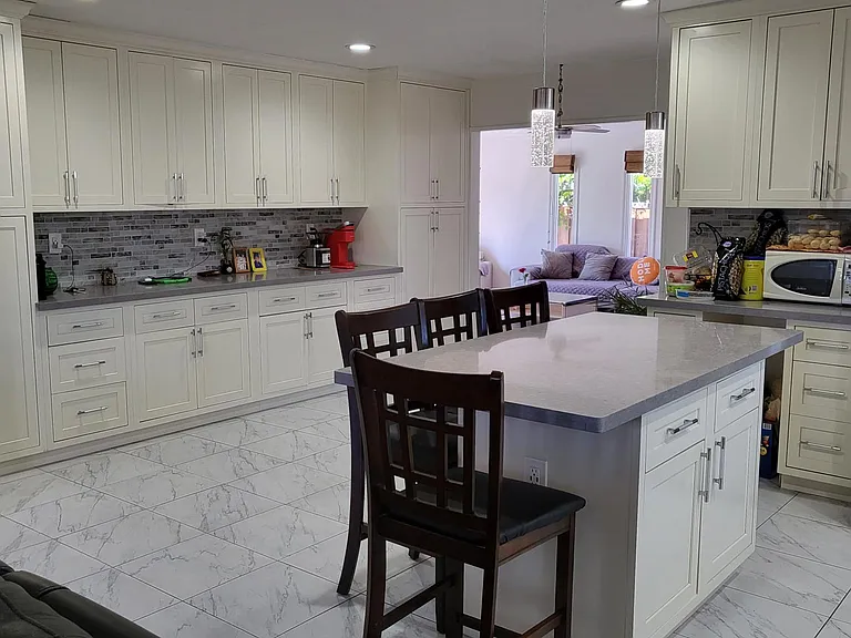 view of the open floor plan and cabinets , island . The dining area leads to the 2nd living room