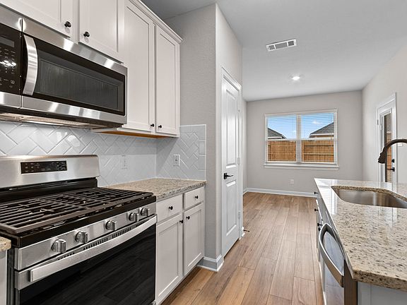 This kitchen has natural light from several windows.