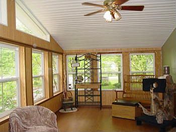 The home is a 3 bedroom two bath manufactured with a nice four seasons room pictured here.