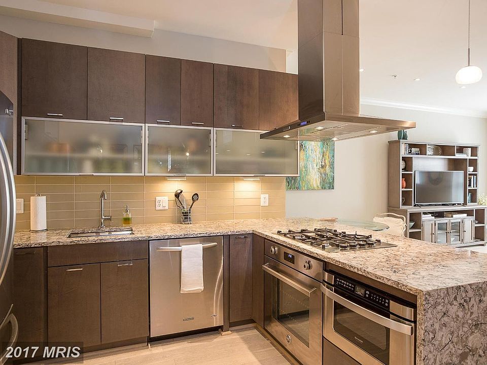 Waterfall style granite countertops with high end appliances