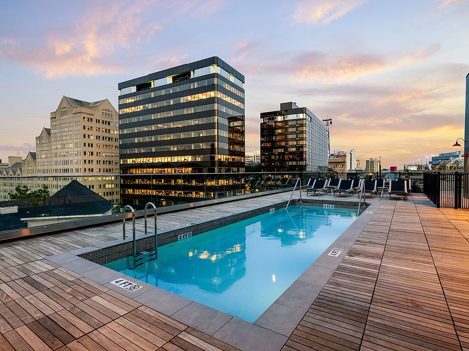 Rooftop lounge area featuring poolside seating and cabanas