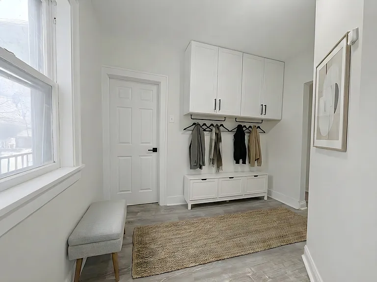 Entryway is large and has space for coats, shoes, bench, or table.