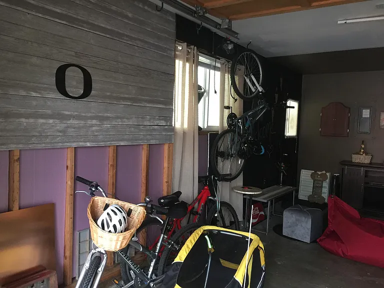Garage that hold bikes dart board fireplace and seating arou