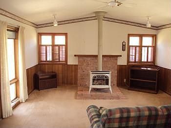 This main floor family room was added to the home in 1981. There is a gas fireplace and a door accessing the deck.