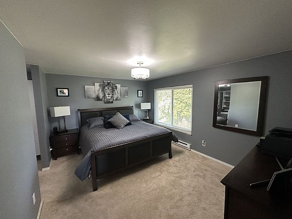 large primary bedroom with walk-in closet and private bathroom