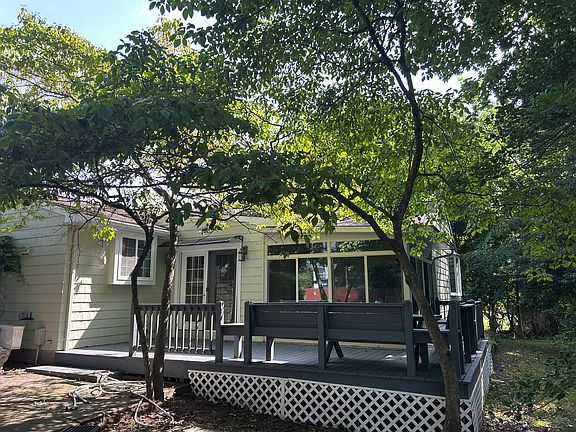 Rear deck with built in seating off sun room.