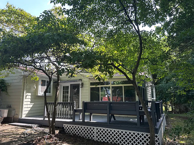 Rear deck with built in seating off sun room.