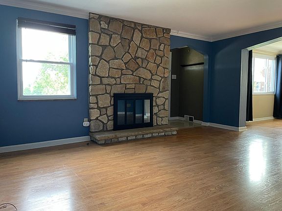 Gas fireplace in living room with plenty of natural light