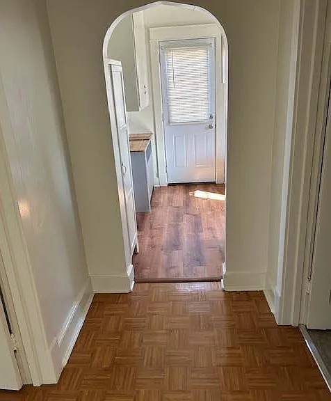 Hallway leading into kitchen and side exit door.