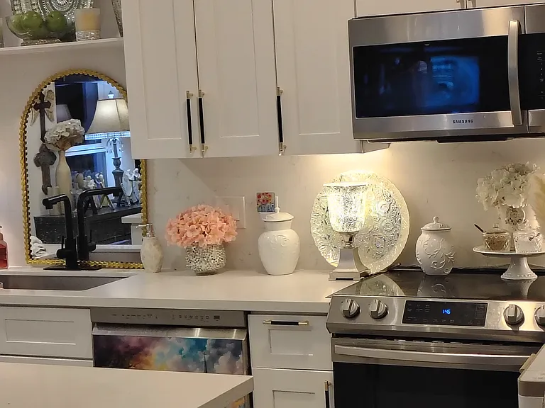 Partial view of kitchen with newer (2023) stainless steel appliances tons of cabinets and soft-close drawers.