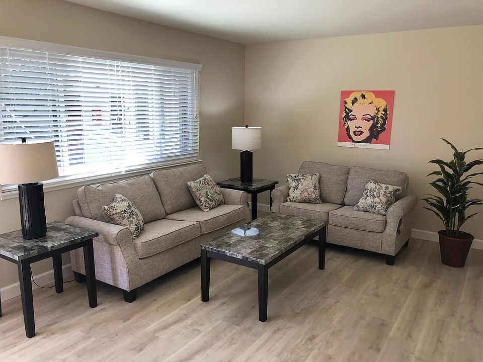 Modern living room with new recessed lighting, new feau wood miniblinds, and media wall.