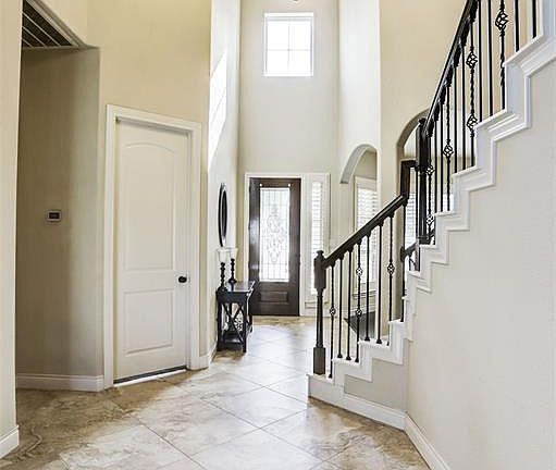 You will enter the home into the stunning two story entry with large chandelier and window over the leaded glass front door to give tons of natural light into the entrance.