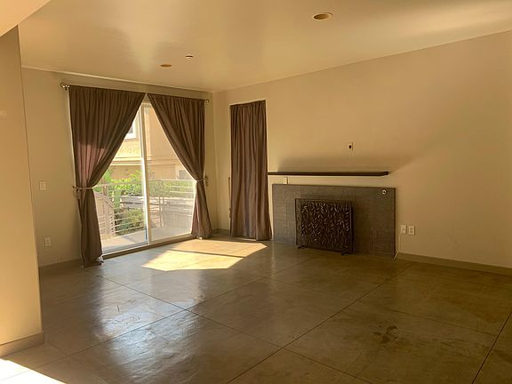 Living room with concrete floors and sunny western exposure.