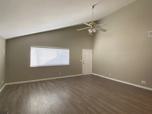 Large living room with vaulted ceilings and wood burning fireplace