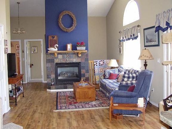 Living room w/ walkout deck and gas log fireplace