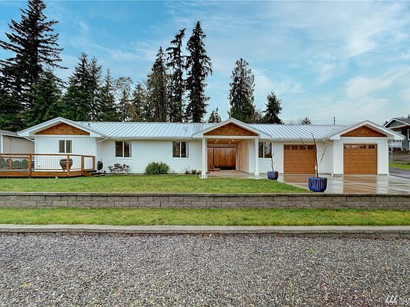 Newer concrete driveway and metal roof. 
