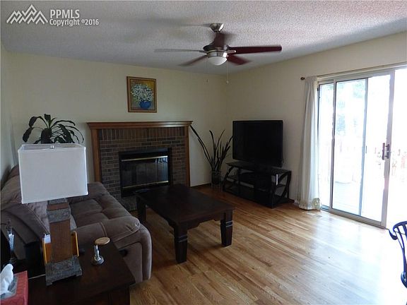 Family room with hardwoods and wood burning fireplace, walk out to deck