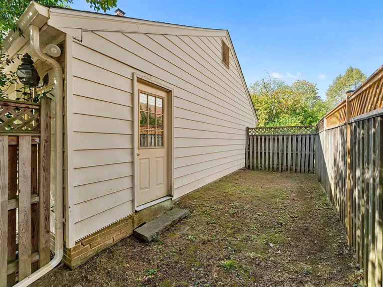 Fenced-in dog run or garden bed area