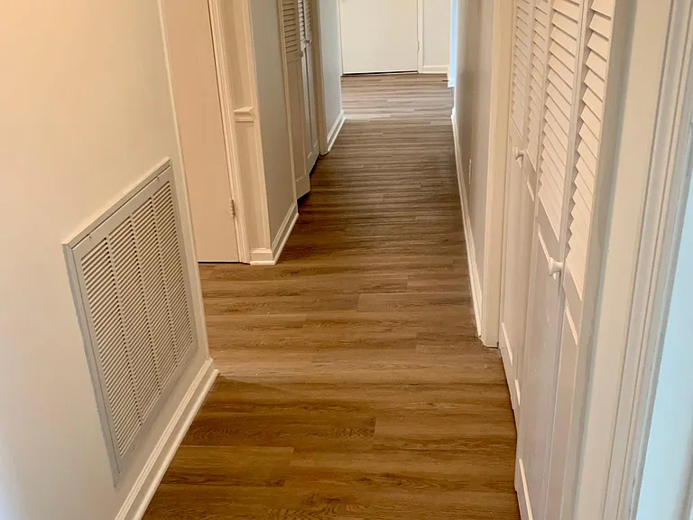 Central hallway looking at the front door. Washer and Dryer located in hallway, along with the coat closet.