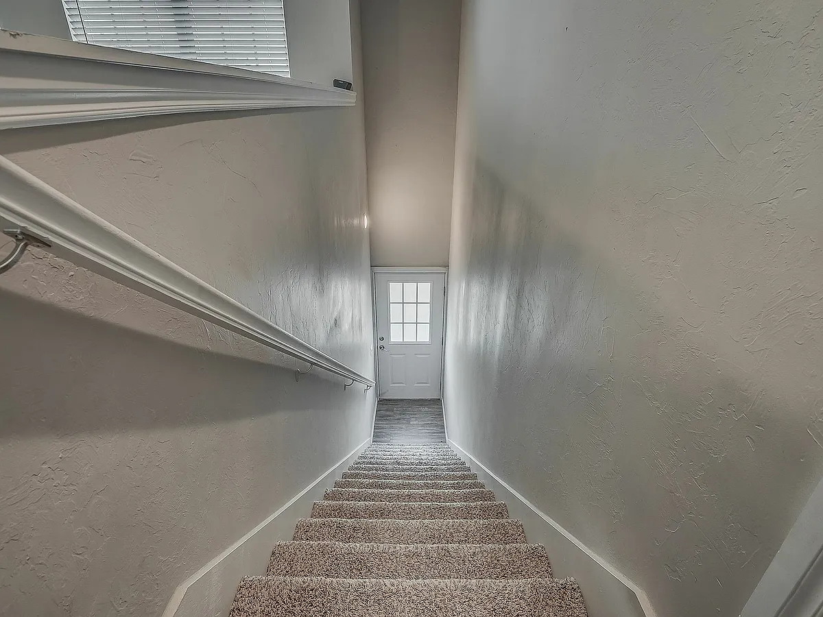 Welcome home with this airy and inviting staircase entrance. - 15501 N Pennsylvania Ave