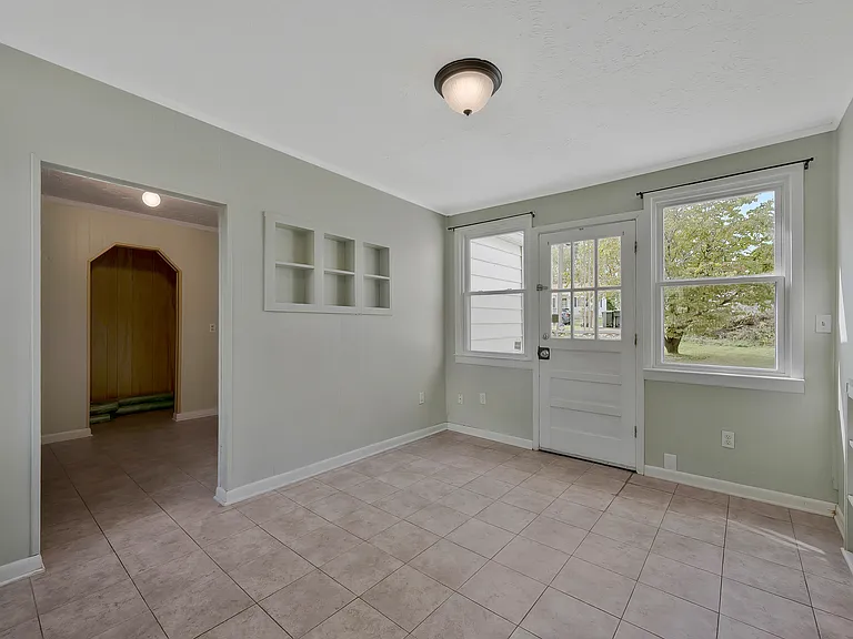 Photo 13. Another view of open dining area, with second exit and entry into laundry room