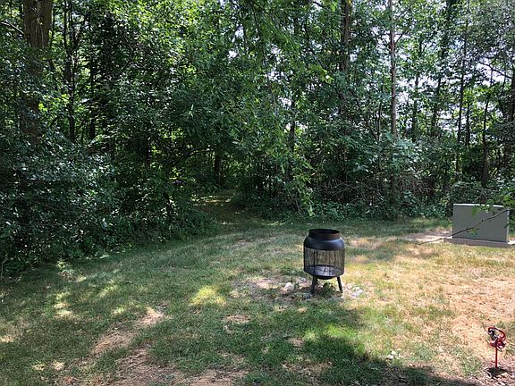 Backyard with path way leading to near by pond. (Fire pit no