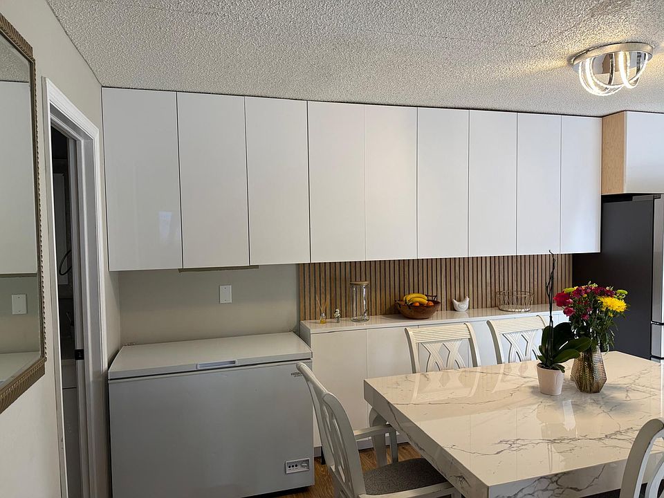 Sleek, modern kitchen with European soft-close cabinets and a large dining area